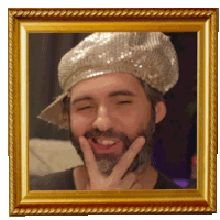 a picture of a man with a beard wearing a hat and making a peace sign