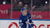 a hockey player with the number 16 on his jersey is standing on the ice