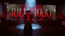 a woman is standing in front of a large screen that says julia hart