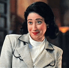 a woman is wearing a white turtleneck and a white jacket