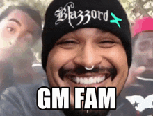 a man wearing a beanie that says blazzard gm fam