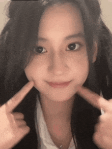 a close up of a girl making a face with her hands