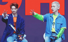 two men are sitting next to each other and one of them is wearing a shirt that says ' supreme '