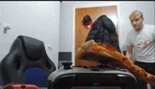 a slice of pizza sitting on top of a xbox controller