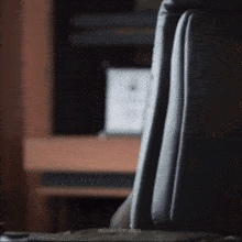 a close up of a black leather office chair with the word minimal on it