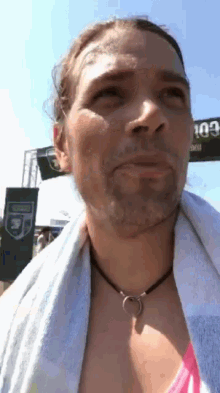 a woman with a towel around her neck looks up at the sky