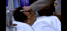 a man laying in a hospital bed with a sony wan logo on the bottom