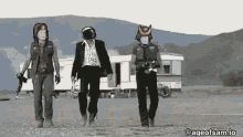 a group of people are walking in a field with the ageofsam.io written on the bottom