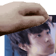 a hand is holding a picture of a man 's head .