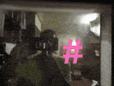a person is taking a selfie with a pink hashtag on the mirror
