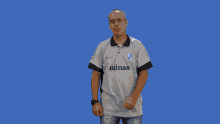 a man covering his face with his hands wearing a shirt that says ' allianz ' on it