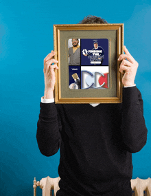 a man is holding a framed picture that says finding a unicorn on it