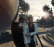 a man in a white suit is standing in front of a large object