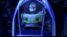a toy story character named buzz lightyear is sitting in a spaceship