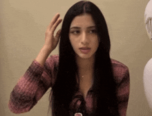 a woman in a pink shirt has a name tag that says ' a.m. ' on it