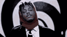 a man in a suit and tie with a scarf on his head .