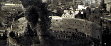 an aerial view of a city with buildings and a monster in the background