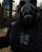 a man wearing a gas mask and a black jacket