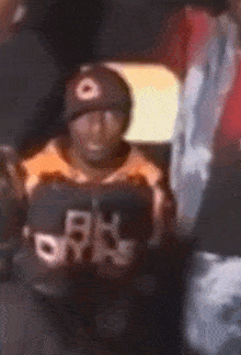 a blurry picture of a person wearing a hat and a shirt that says ' n.y. ' on it .