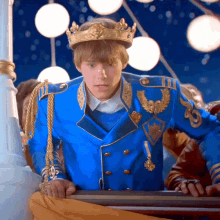 a man in a blue uniform with a gold crown on his head