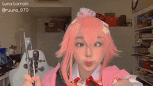 a woman in a pink wig is holding a pair of scissors and making a funny face .
