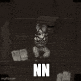 a black and white image of a person tied up in a room with the word nn on the bottom .