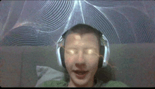 a man wearing headphones has a glowing eye