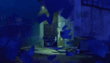 a person is standing in a dark room with a blue light behind them .