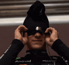 a man wearing a black shirt with the word android on it