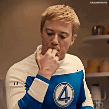 a man wearing a blue and white sweater with the number four on it