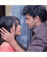 a man and a woman are looking at each other and touching their foreheads