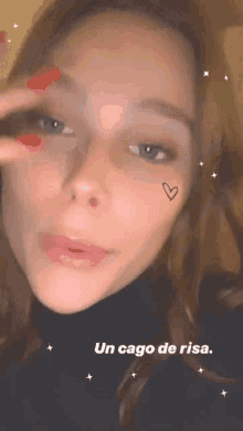 a close up of a woman 's face with a heart on her face and the words un cago de risa .