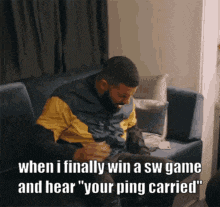 a man is sitting on a couch playing a video game and says when i finally win a sw game