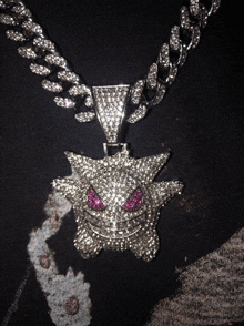 a necklace with a pendant that looks like a monster