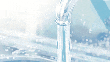 a close up of a faucet with water pouring out