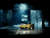a yellow sports car is driving through a tunnel in the dark