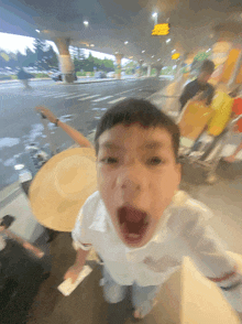 a blurry picture of a boy making a funny face with his mouth open