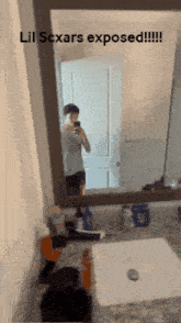 a man taking a picture of himself in a bathroom mirror with the caption lil scxars exposed !!!
