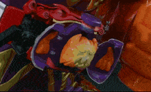 a close up of a purple and orange object that looks like a robot