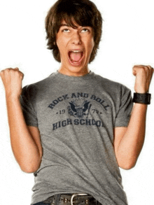 a boy wearing a rock and roll high school t-shirt
