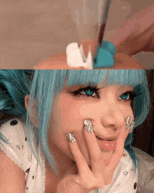 a woman with blue hair and silver nail polish on her nails is smiling