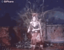 a skeleton is dancing in a dark room in a video game .