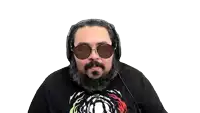 a man with a beard and sunglasses is wearing headphones