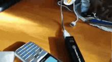 a cell phone is plugged into a charger that says ' schneider ' on it
