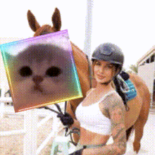 a woman is riding a horse and holding a square with a cat on it