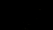 a man sits in a chair in a dark room with a record player