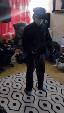a man wearing a virtual reality headset stands on a rug