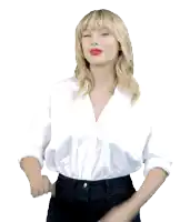 a blonde woman wearing a white shirt and black pants is clapping her hands