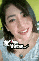 a close up of a woman 's face with the words horas written on it