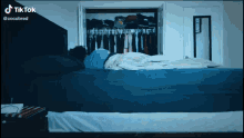 a tiktok video shows a person laying on a bed in a closet